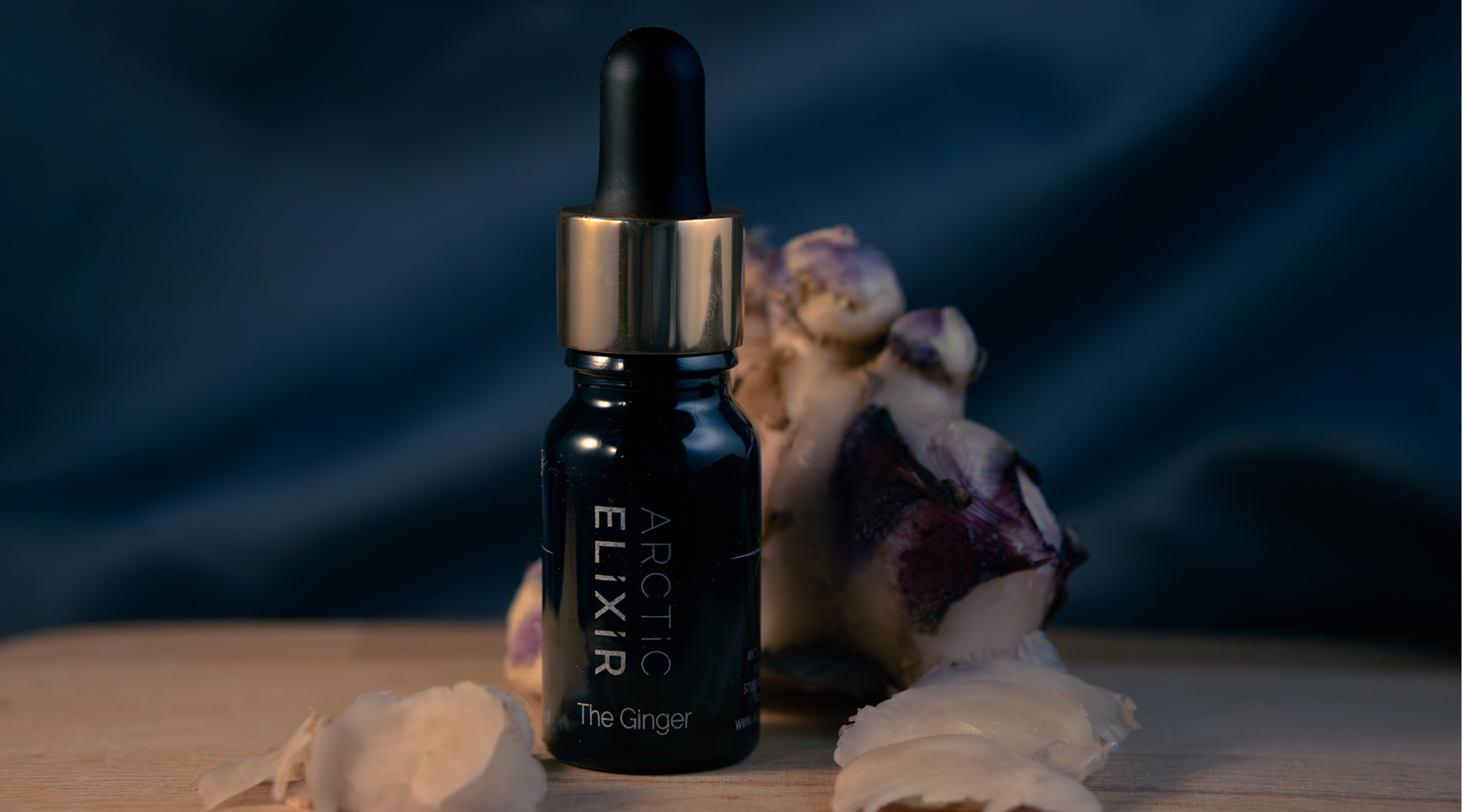 The Ginger oil bottle on fresh ginger background